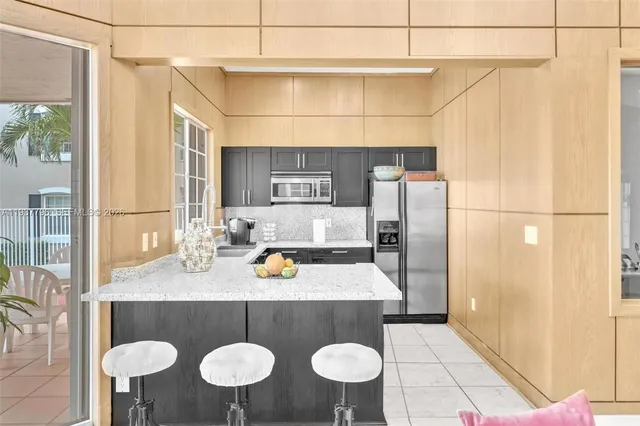 a kitchen with a sink and a refrigerator