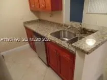 a kitchen with a sink a cabinets and window