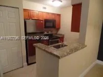 a kitchen with a stove and a microwave