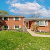 a view of a house with a backyard
