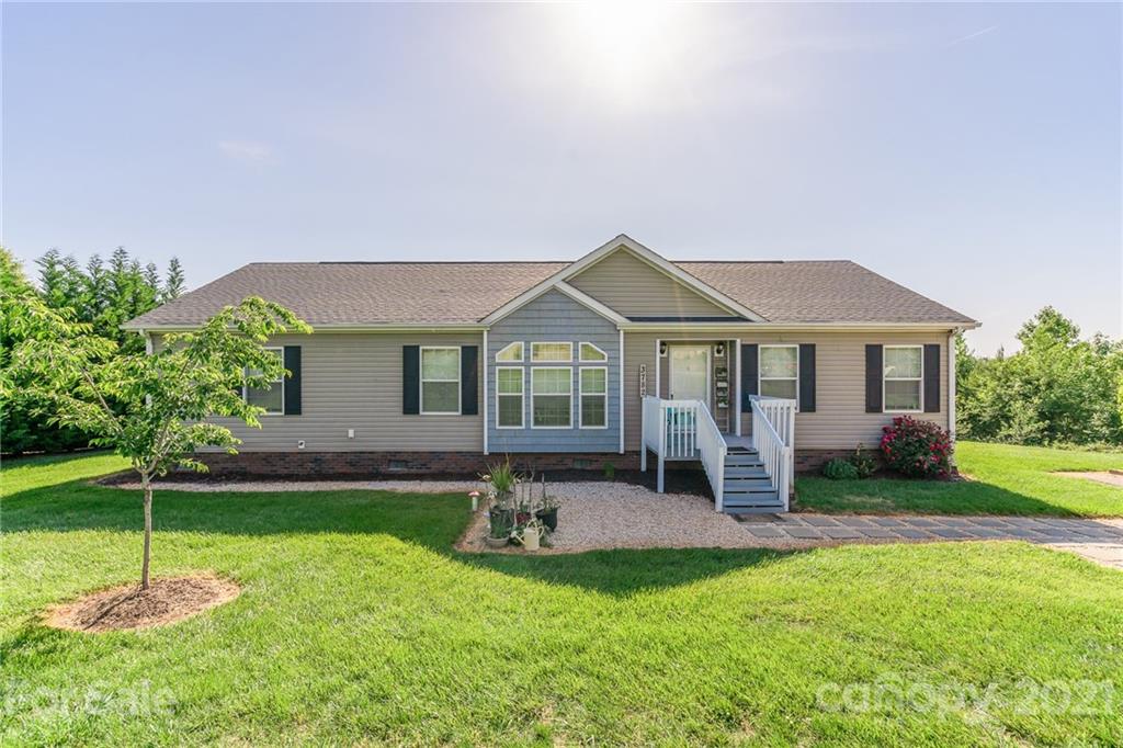 a front view of a house with a yard and porch
