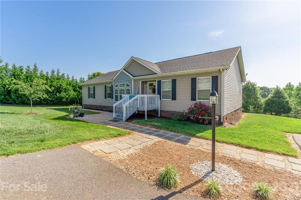 3782 Banoak Road Vale, NC 28168 - Photo 11 of 36 a front view of a house with a garden and plants