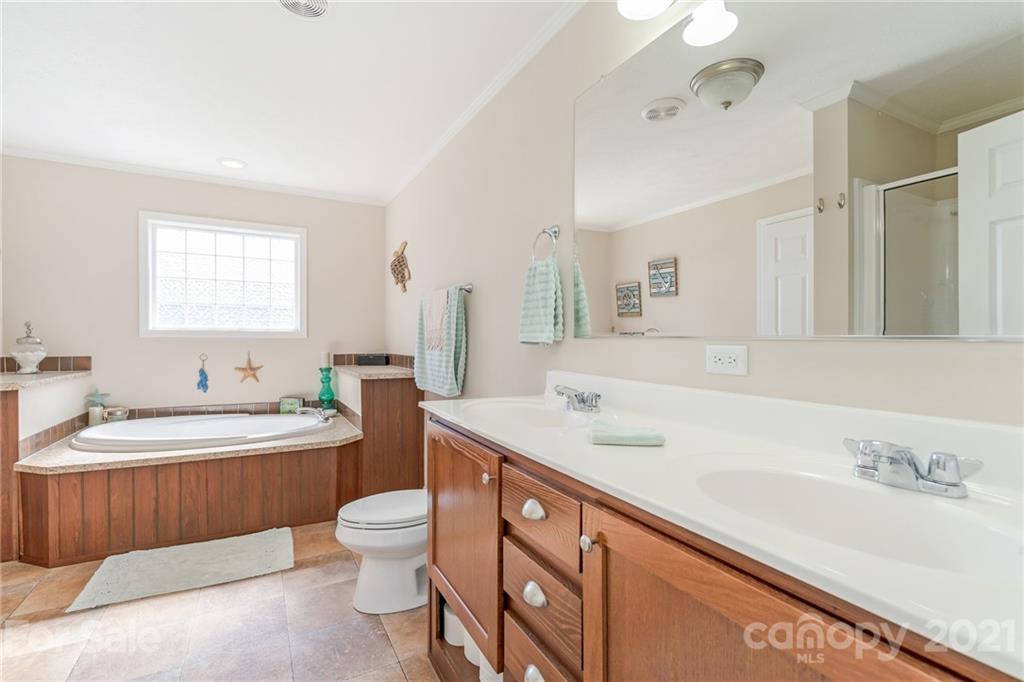 3782 Banoak Road Vale, NC 28168 - Photo 15 of 36 a bathroom with a double vanity sink toilet mirror and bathtub
