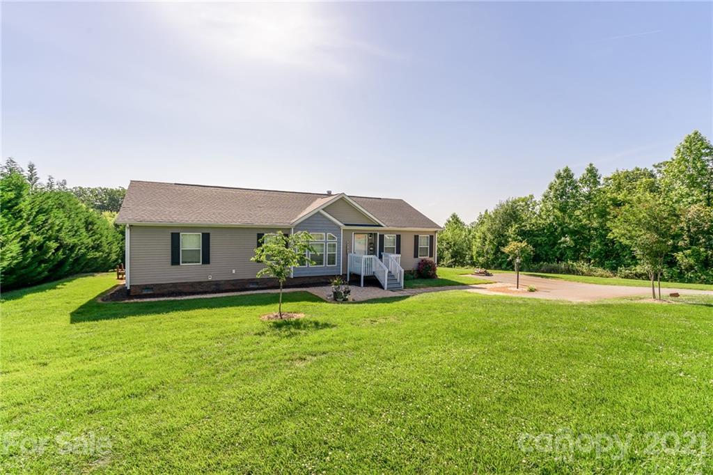 3782 Banoak Road Vale, NC 28168 - Photo 3 of 36 a front view of a house with a yard and garage