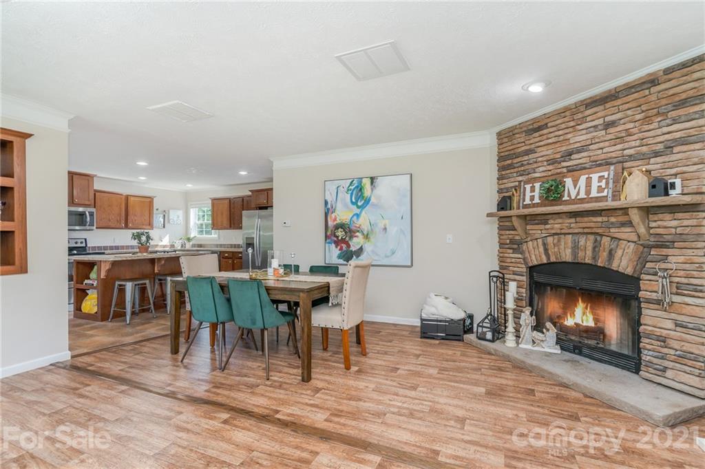 3782 Banoak Road Vale, NC 28168 - Photo 31 of 36 a living room with furniture a fireplace and kitchen view