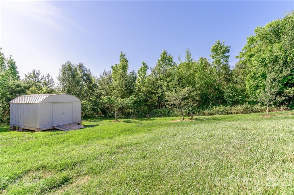 3782 Banoak Road Vale, NC 28168 - Photo 7 of 36 a view of a field with potted plants and big trees