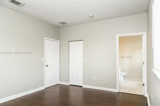an empty room with wooden floor