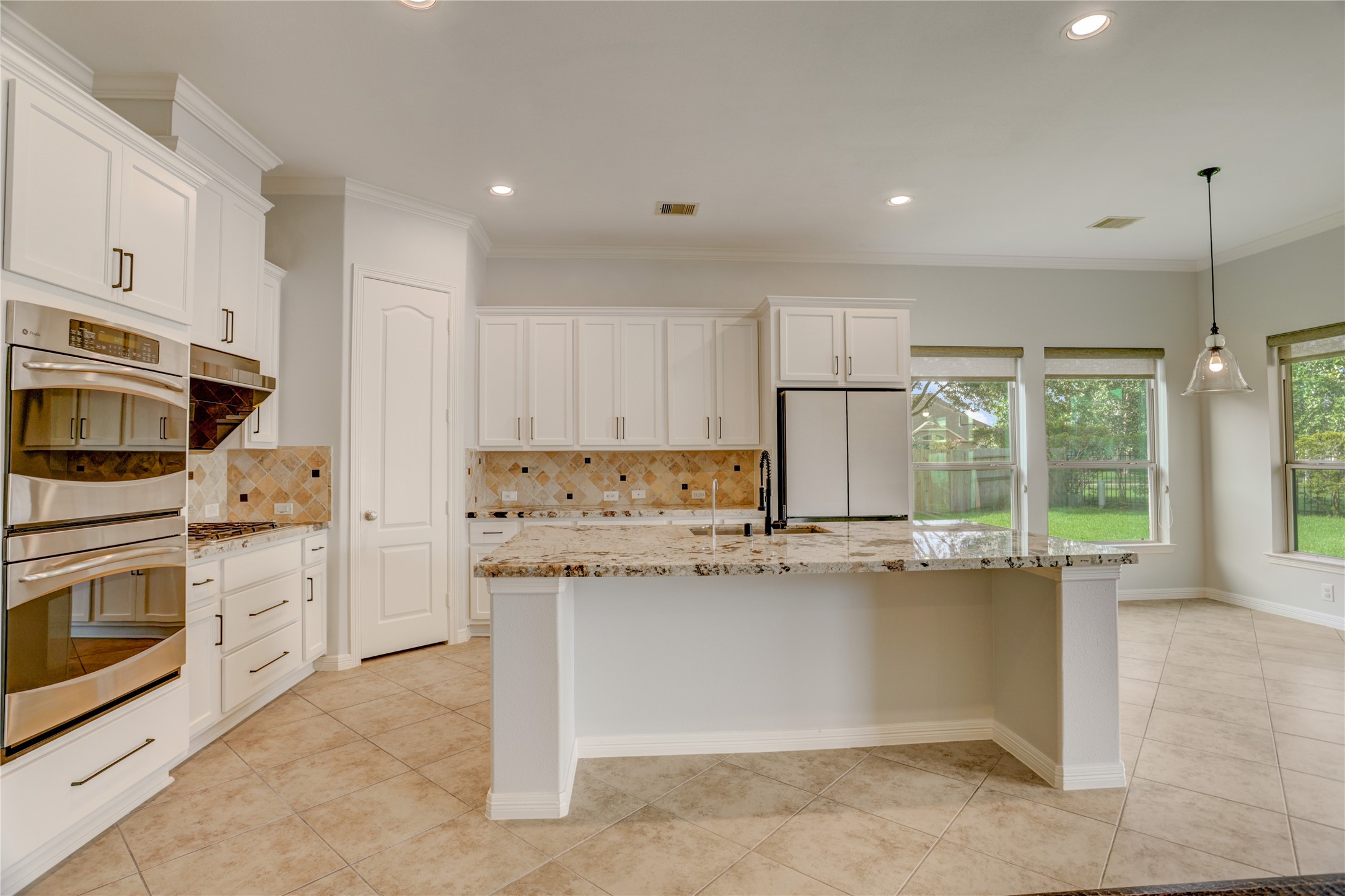 3002 Currant Drive Manvel, TX 77578 - Photo 14 of 43 a kitchen with stainless steel appliances granite countertop a stove a sink and a refrigerator
