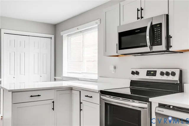 a kitchen with microwave cabinets and stainless steel appliances