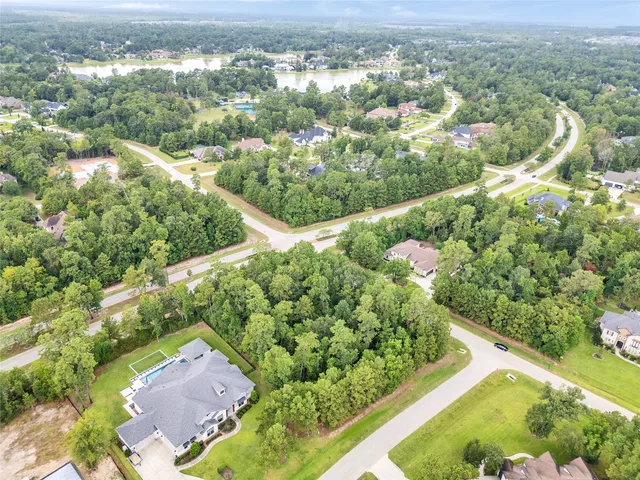 an aerial view of a house with a yard and outdoor seating
