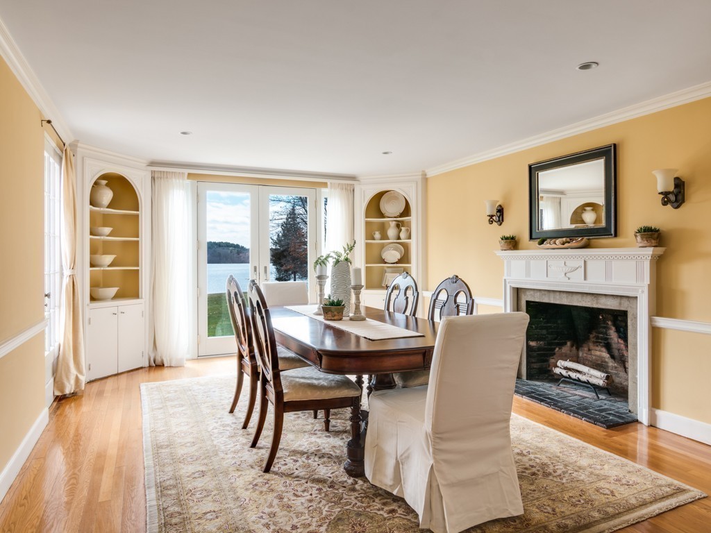 13 Cedar Street Wenham, MA 01984 - Photo 12 of 33 a dining room with furniture a fireplace and wooden floor