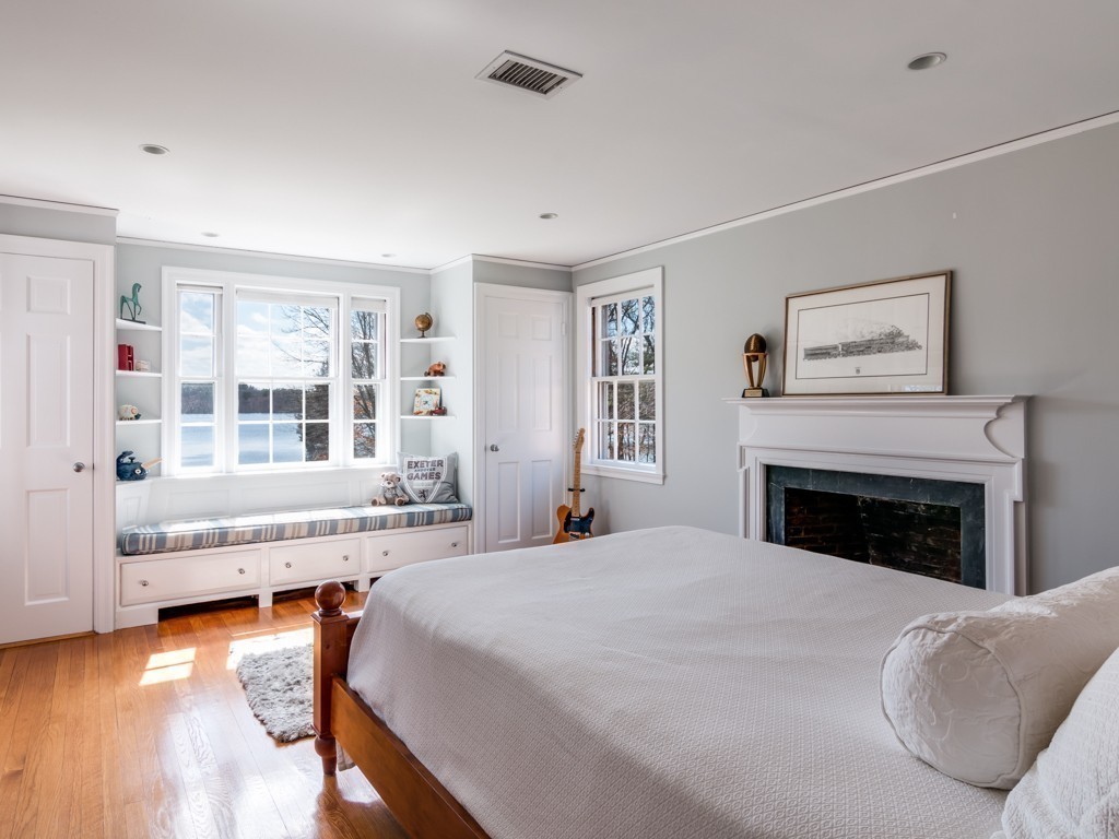 13 Cedar Street Wenham, MA 01984 - Photo 25 of 33 a spacious bedroom with a large bed and a fireplace