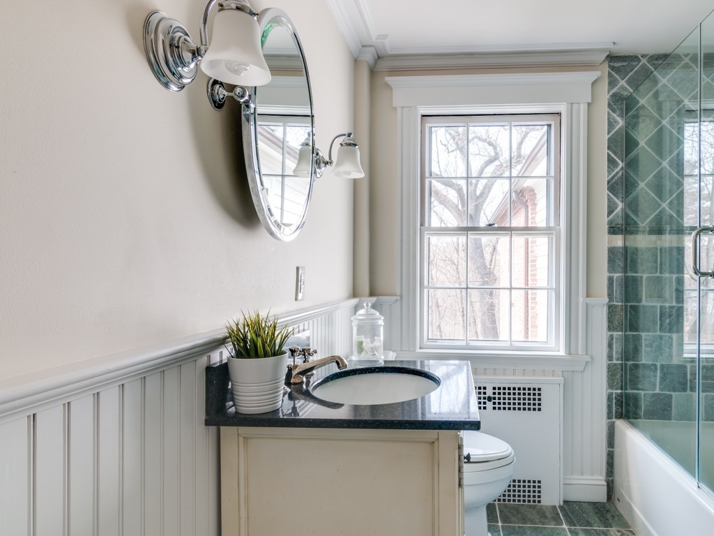 13 Cedar Street Wenham, MA 01984 - Photo 27 of 33 a bathroom with a granite countertop sink a mirror and a window