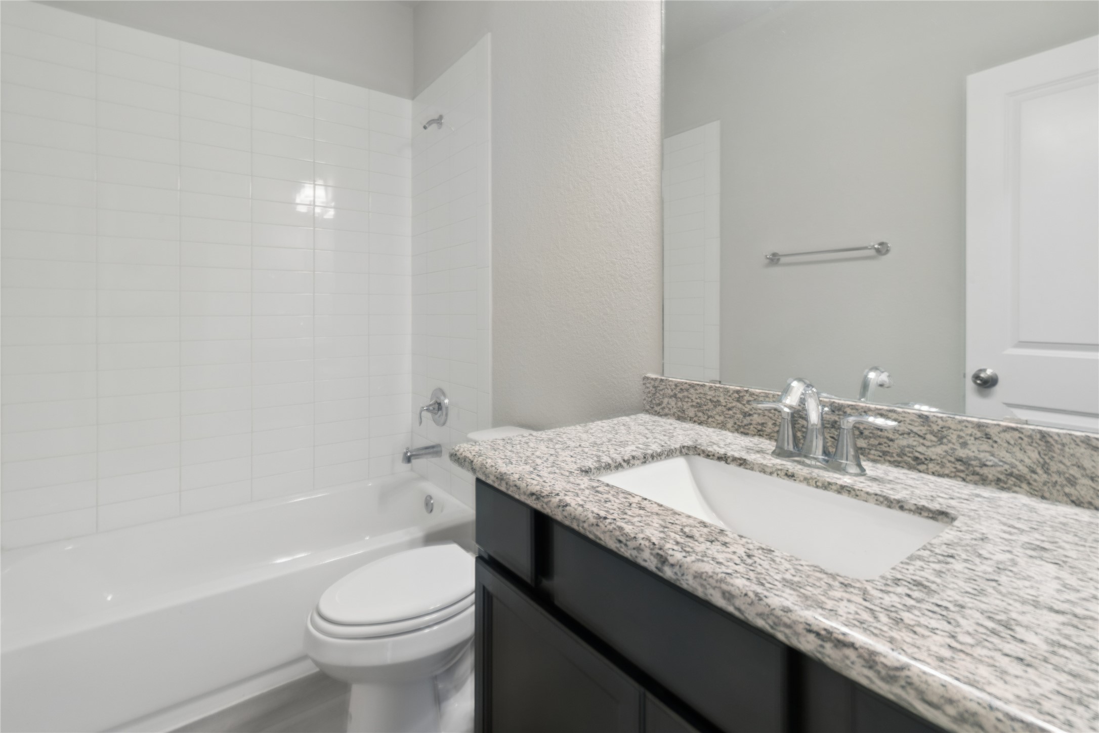 25131 Calvary Charge Magnolia, TX 77355 - Photo 12 of 20 a bathroom with a granite countertop sink a toilet and bathtub