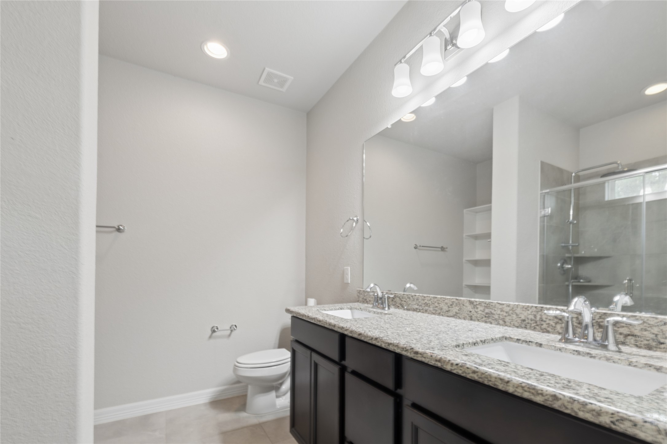 25131 Calvary Charge Magnolia, TX 77355 - Photo 14 of 20 a bathroom with a granite countertop sink a toilet and a mirror