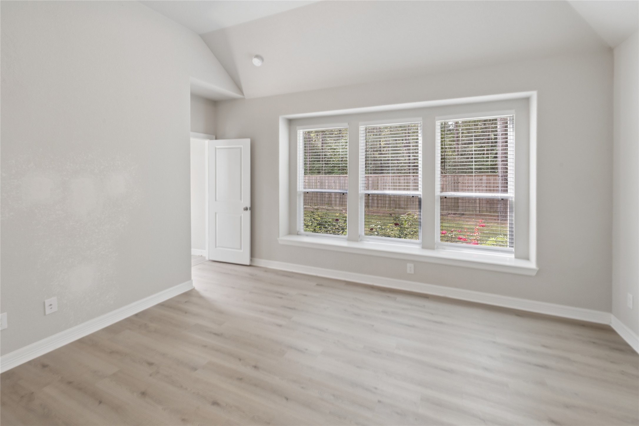 25131 Calvary Charge Magnolia, TX 77355 - Photo 16 of 20 an empty room with wooden floor and windows