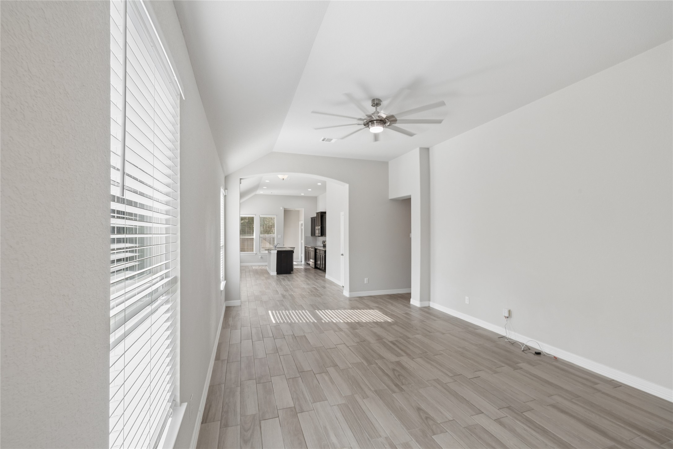 25131 Calvary Charge Magnolia, TX 77355 - Photo 6 of 20 a view of a hallway with wooden floor and chandelier