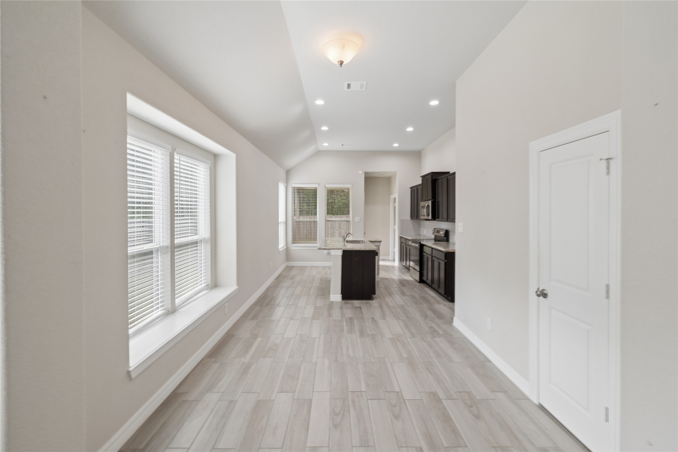 25131 Calvary Charge Magnolia, TX 77355 - Photo 7 of 20 a view of a kitchen with wooden floor and windows
