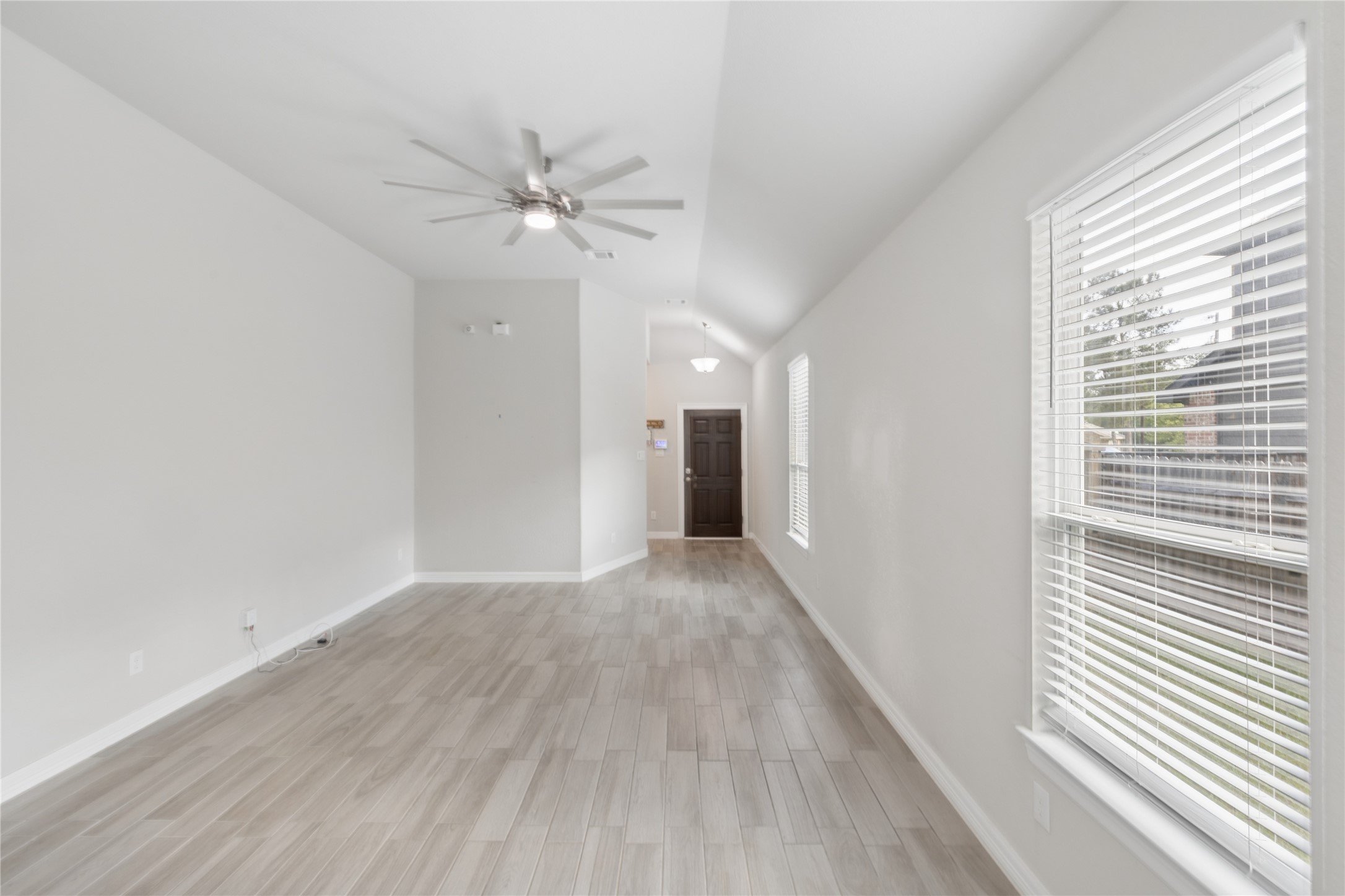 25131 Calvary Charge Magnolia, TX 77355 - Photo 8 of 20 a view of a hallway with wooden floor and a chandelier fan