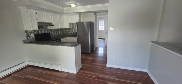 a kitchen with a refrigerator and a stove