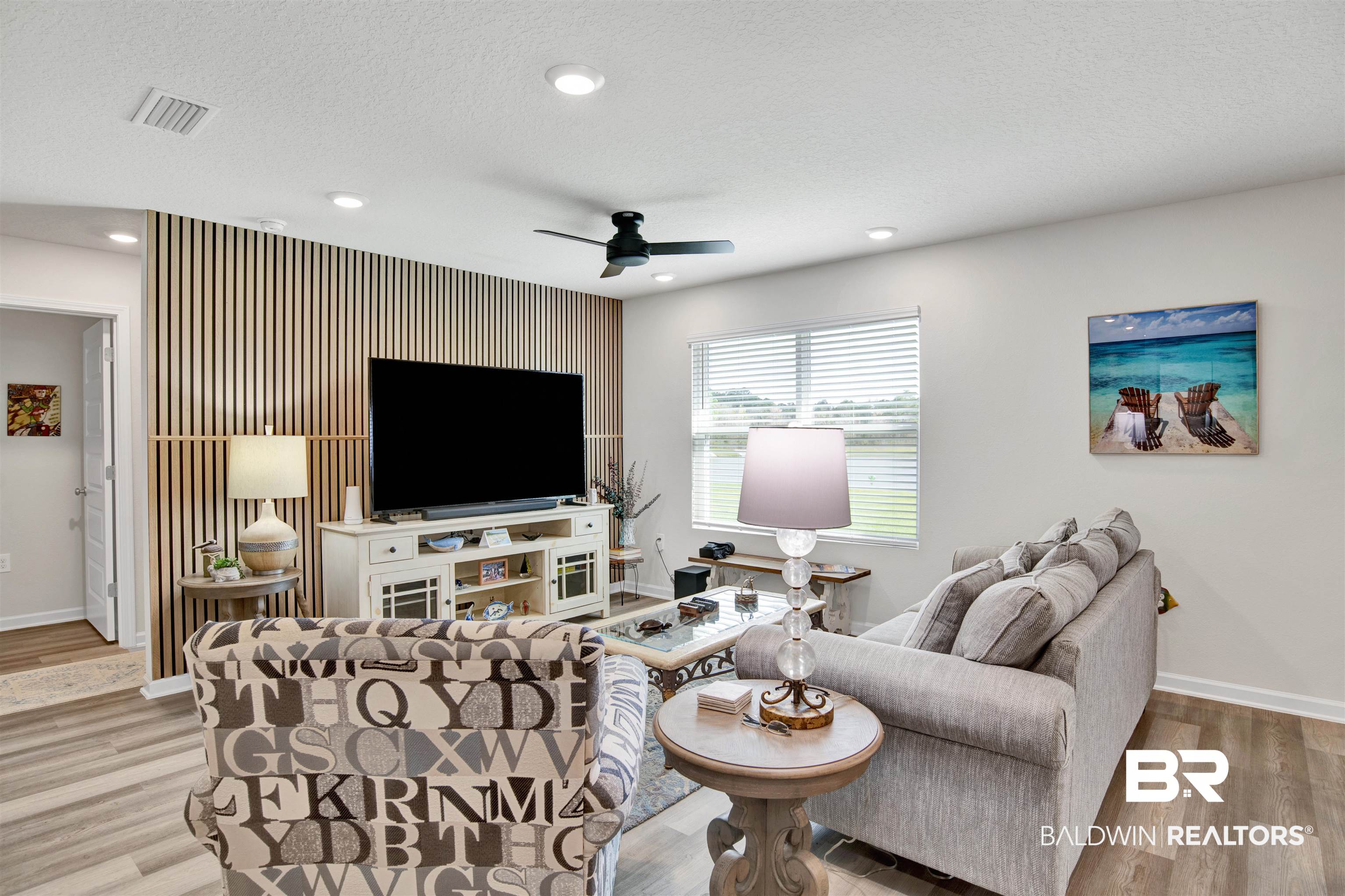 22348 Aleutian Avenue Foley, AL 36535 - Photo 6 of 32 Living room featuring an accent wall, a ceiling fan, light wood-style flooring, recessed lighting, and a textured ceiling