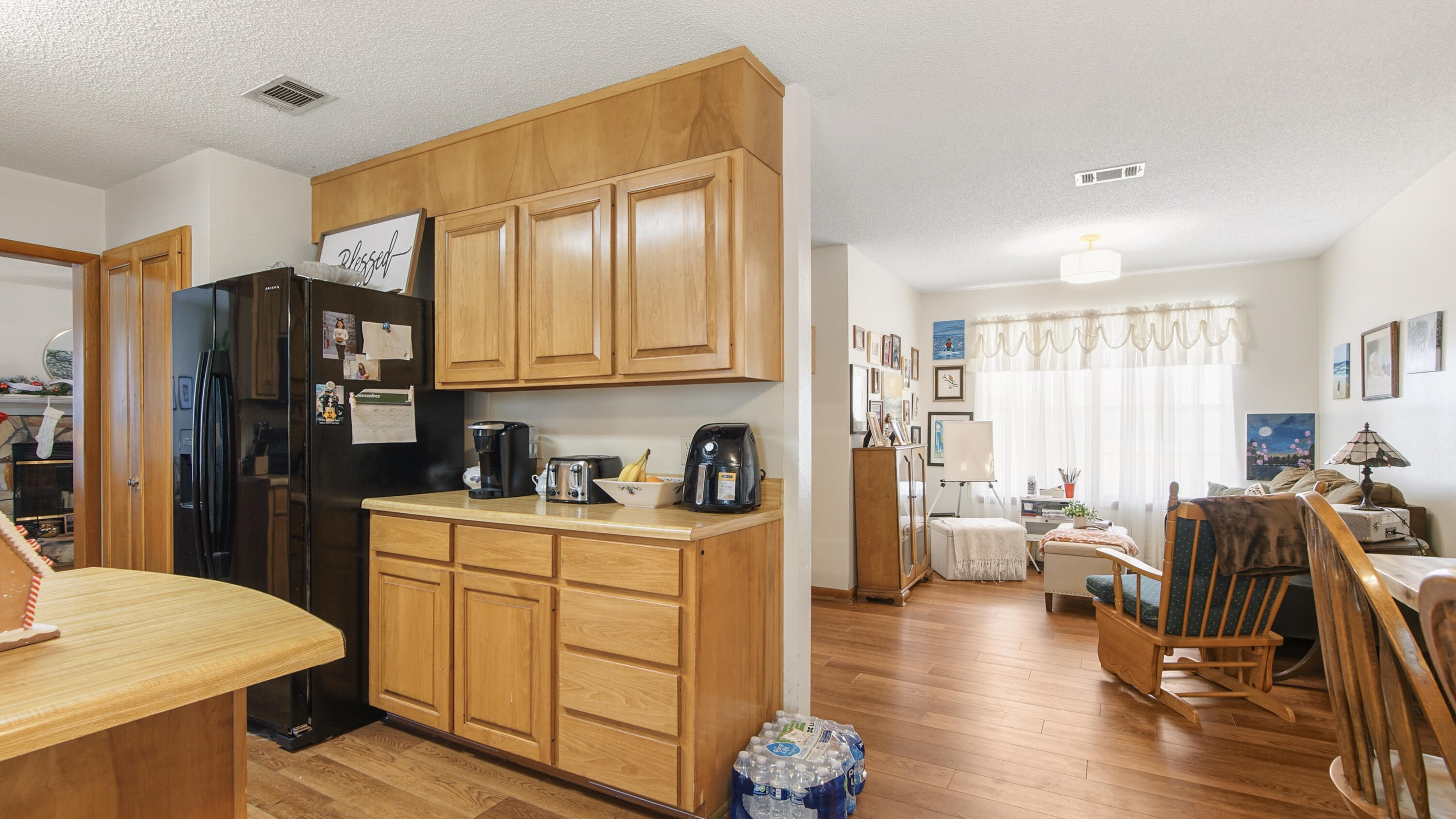 2186 Highway 90 DeFuniak Springs, FL 32433 - Photo 15 of 49 a open kitchen with stainless steel appliances granite countertop a refrigerator a stove top oven a dining table and chairs with wooden floor