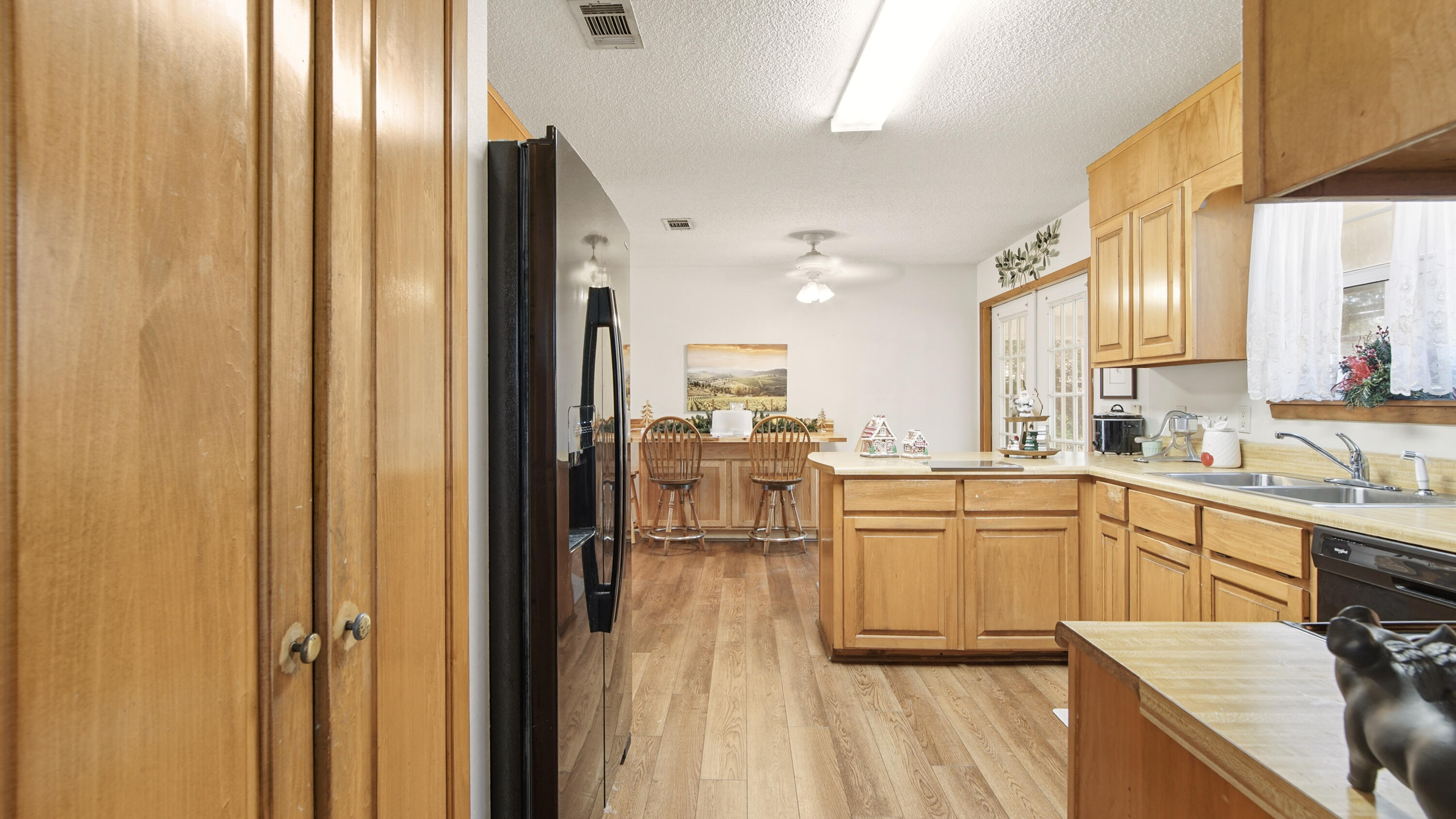 2186 Highway 90 DeFuniak Springs, FL 32433 - Photo 10 of 49 a kitchen with cabinets and wooden floor