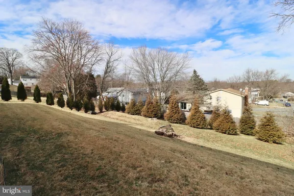 a yellow house with trees in front of it