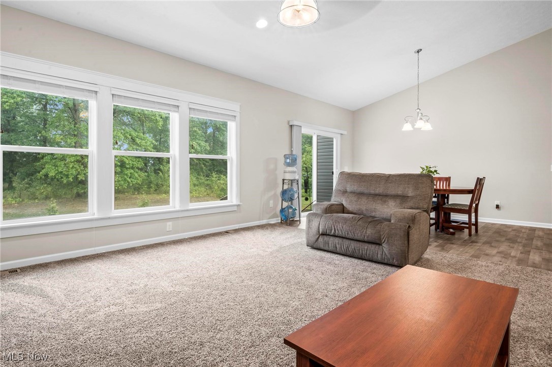 6824 Hatching Way North Ridgeville, OH 44039 - Photo 13 of 42 Living room with carpet, an inviting chandelier, and lofted ceiling