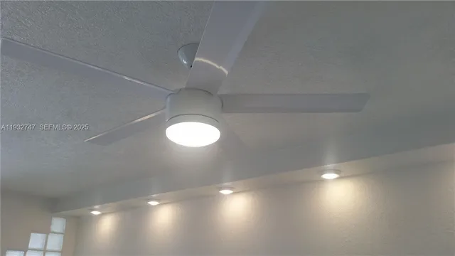view of a room with a cabinet and chandelier