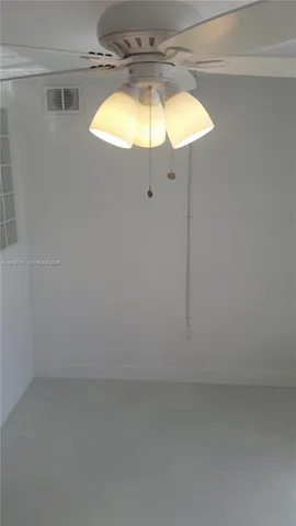 a view of a chandelier fan and a projector in a room