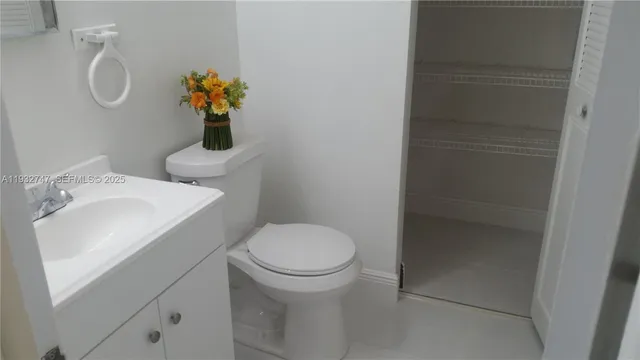 a view of an empty room and a chandelier fan