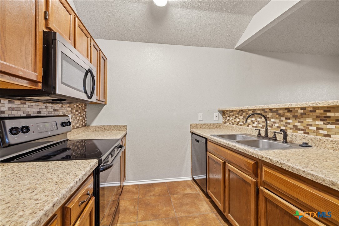 4215 Rifle Drive Killeen, TX 76542 - Photo 12 of 30 a kitchen with a stove and a sink