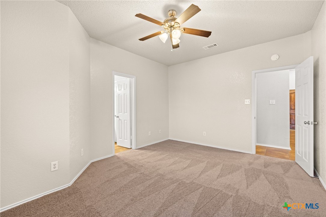 4215 Rifle Drive Killeen, TX 76542 - Photo 16 of 30 an empty room with fan and a chandelier fan
