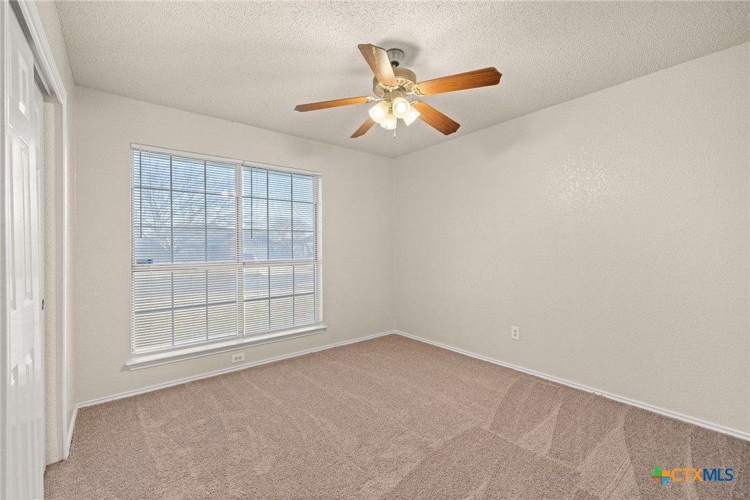 4215 Rifle Drive Killeen, TX 76542 - Photo 19 of 30 an empty room with chandelier fan and windows
