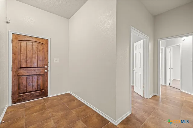 a view of empty room with a fireplace