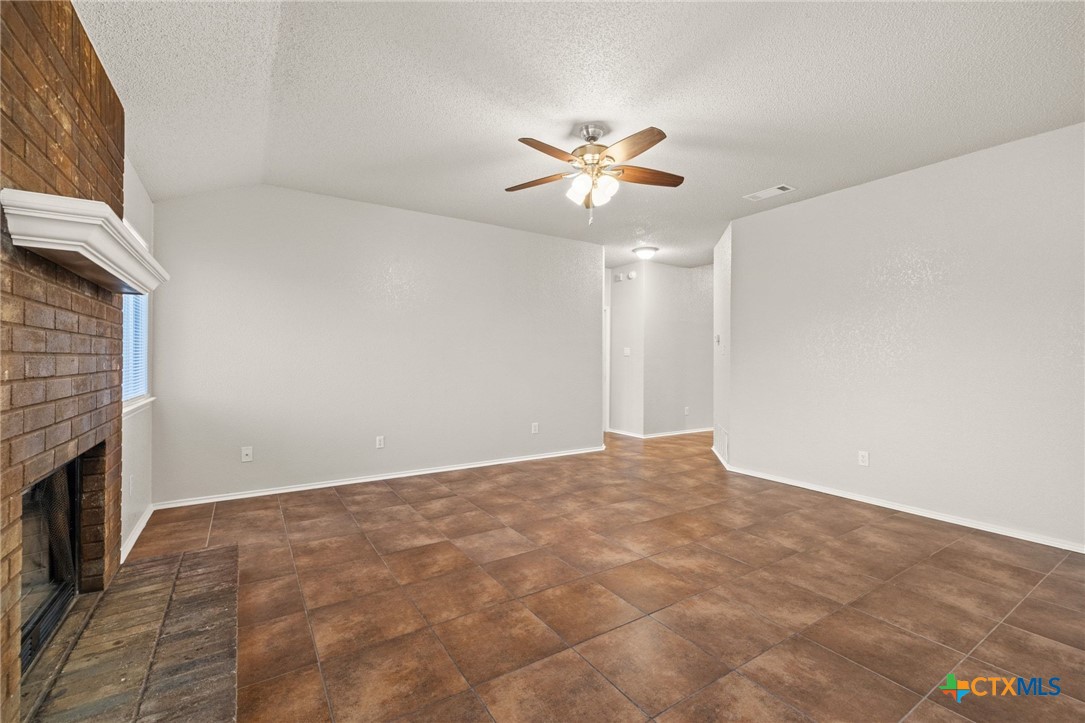 4215 Rifle Drive Killeen, TX 76542 - Photo 8 of 30 a view of an empty room with chandelier fan and fire place