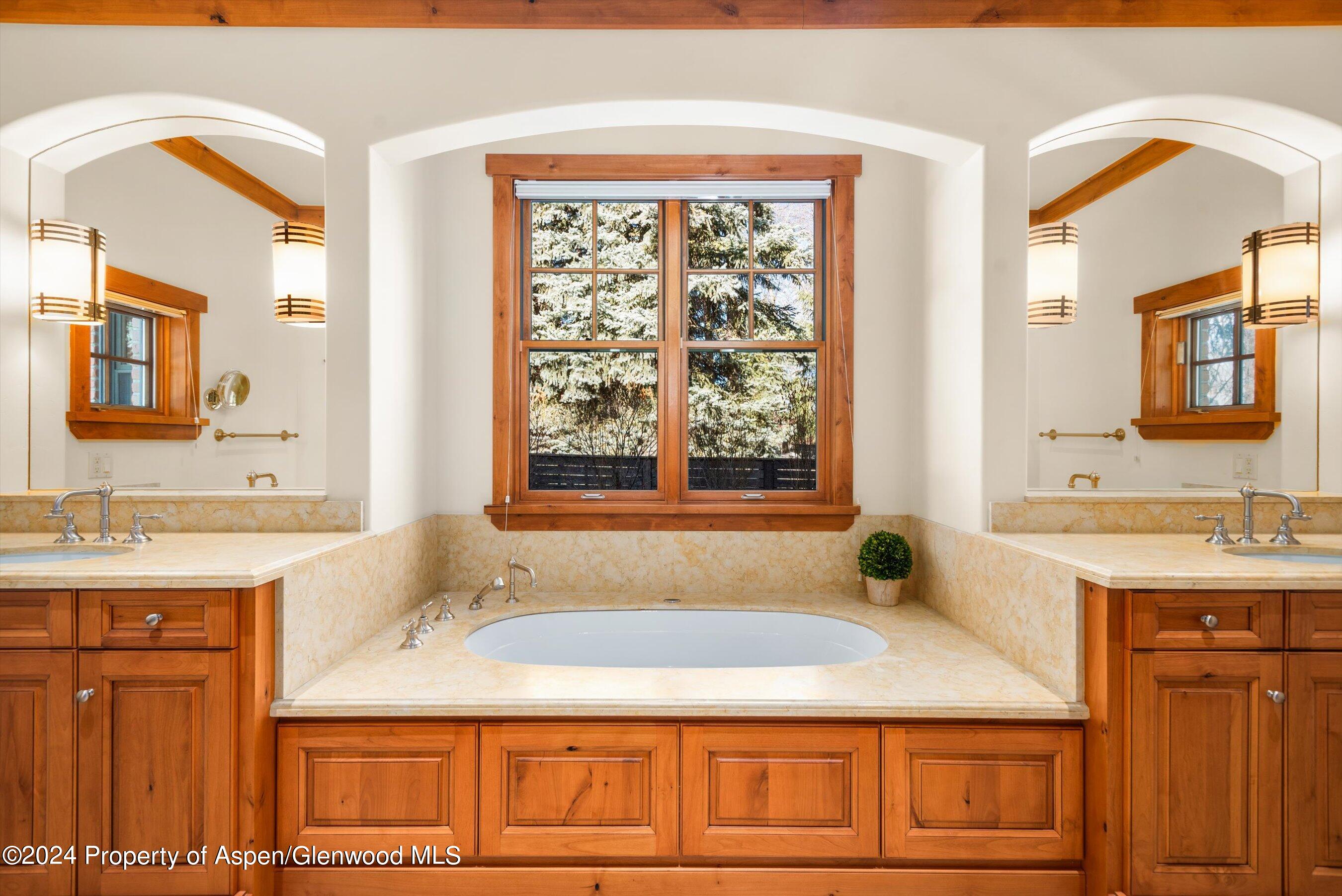 101 South 7th Street, Unit A Aspen, CO 81611 - Photo 13 of 35 a bathroom with a granite countertop tub sink and mirror