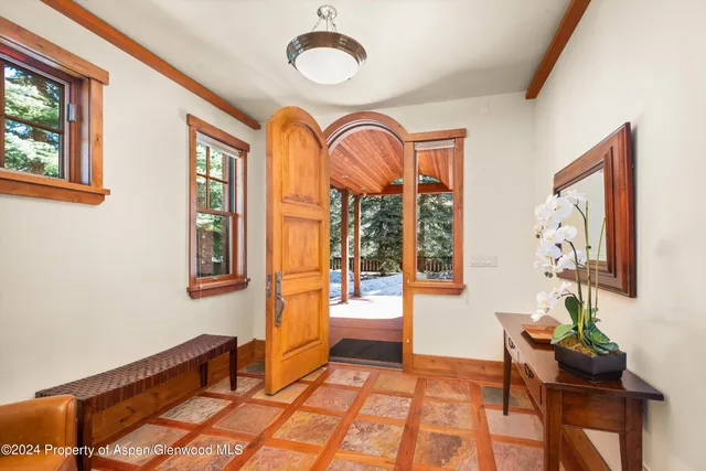 a view of hall way with furniture and windows