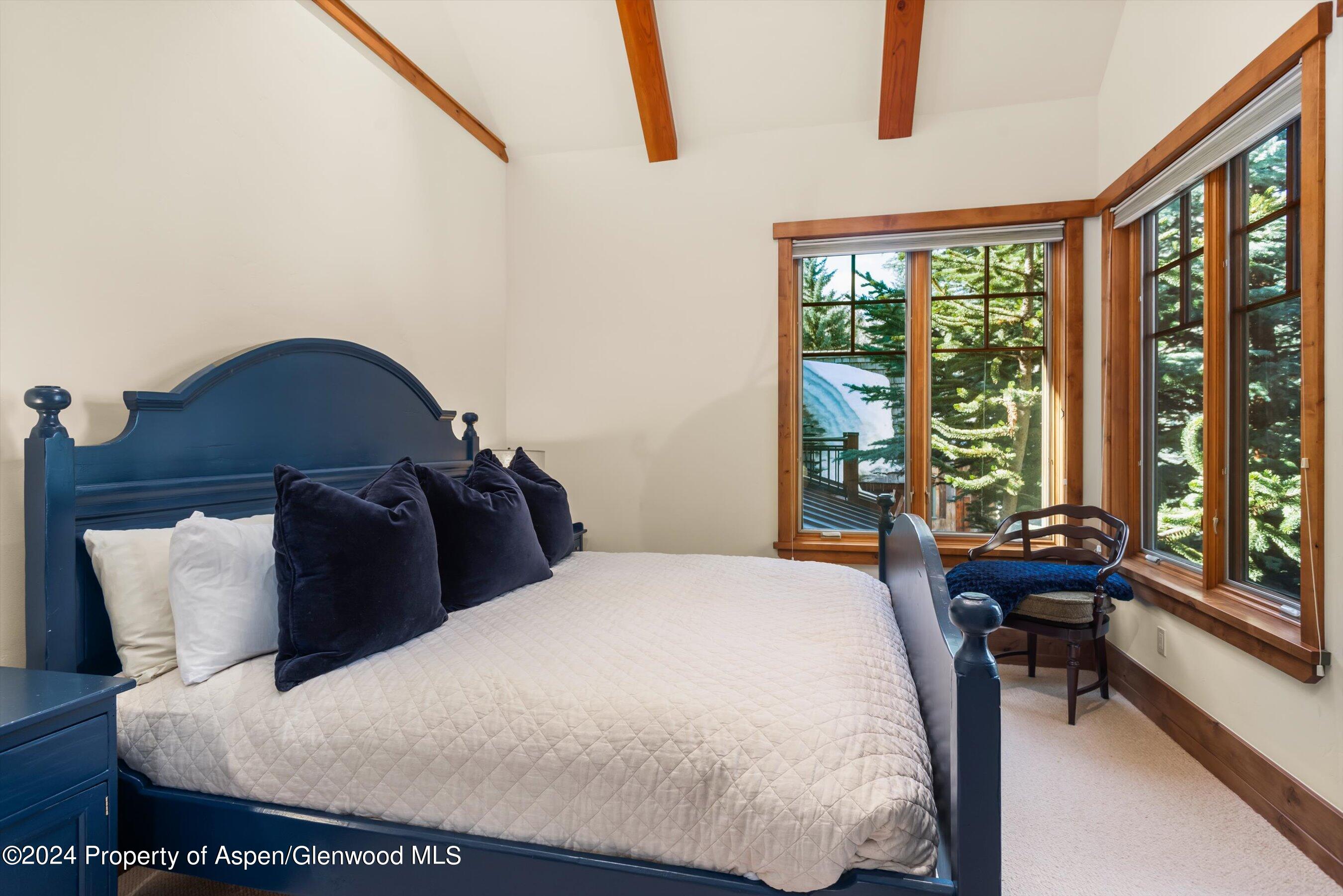 101 South 7th Street, Unit A Aspen, CO 81611 - Photo 22 of 35 a bed sitting in a bedroom next to a window