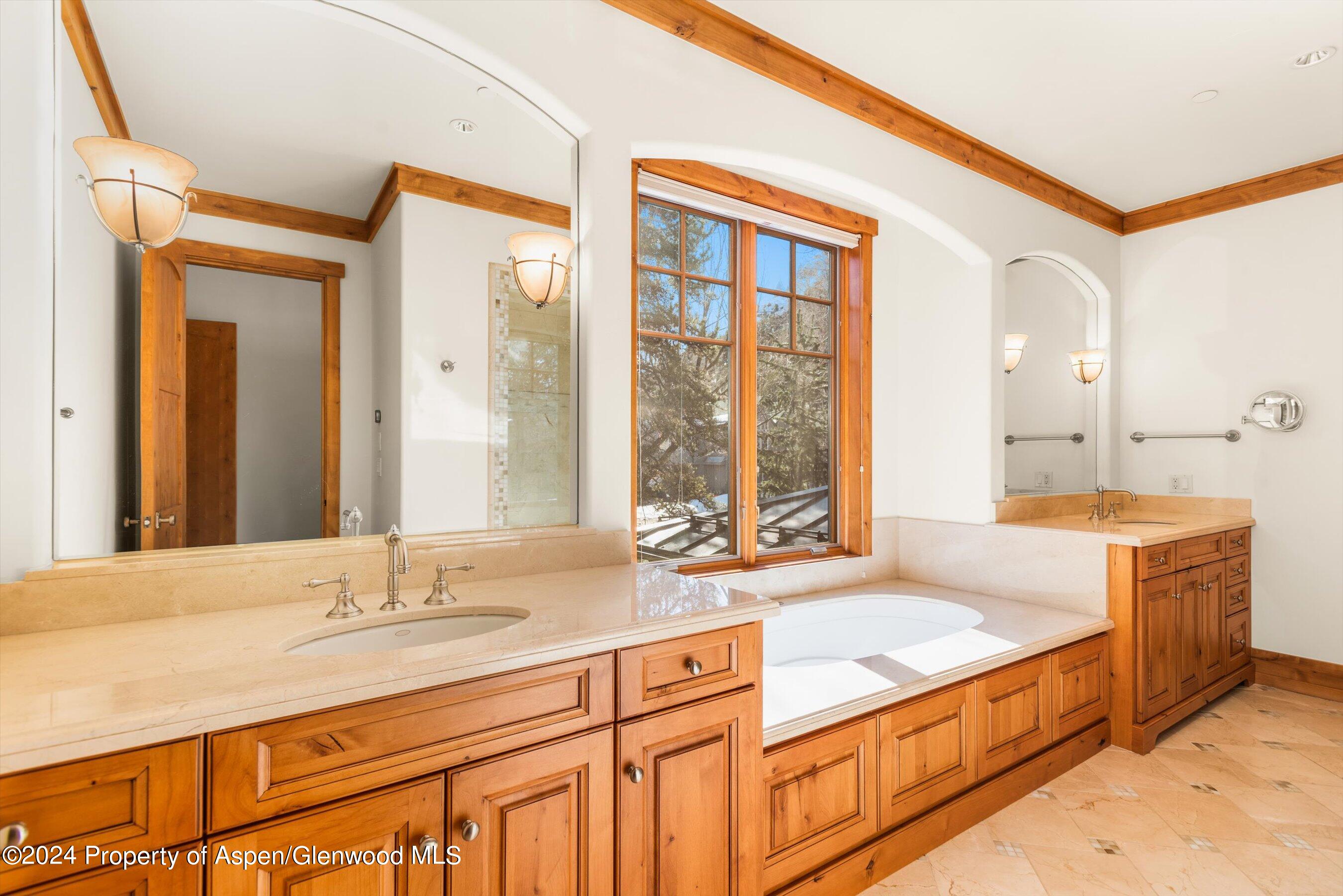 101 South 7th Street, Unit A Aspen, CO 81611 - Photo 24 of 35 a spacious bathroom with a granite countertop sink and a large mirror