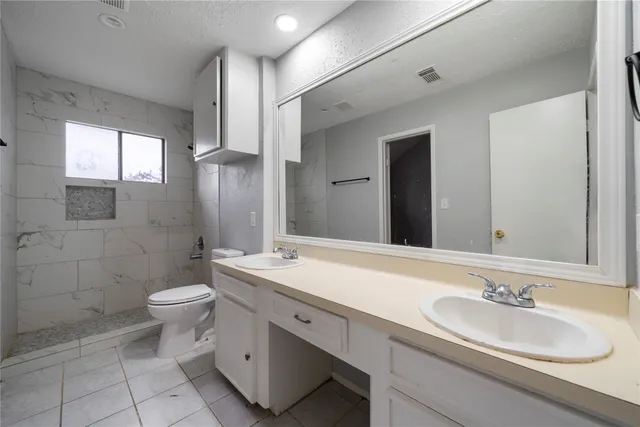 a view of a big room with wooden floor and windows