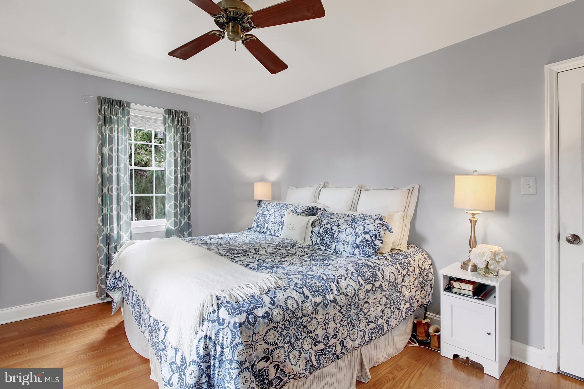 150 Dumbarton Road Baltimore, MD 21212 - Photo 11 of 30 a bedroom with a bed and wooden floor