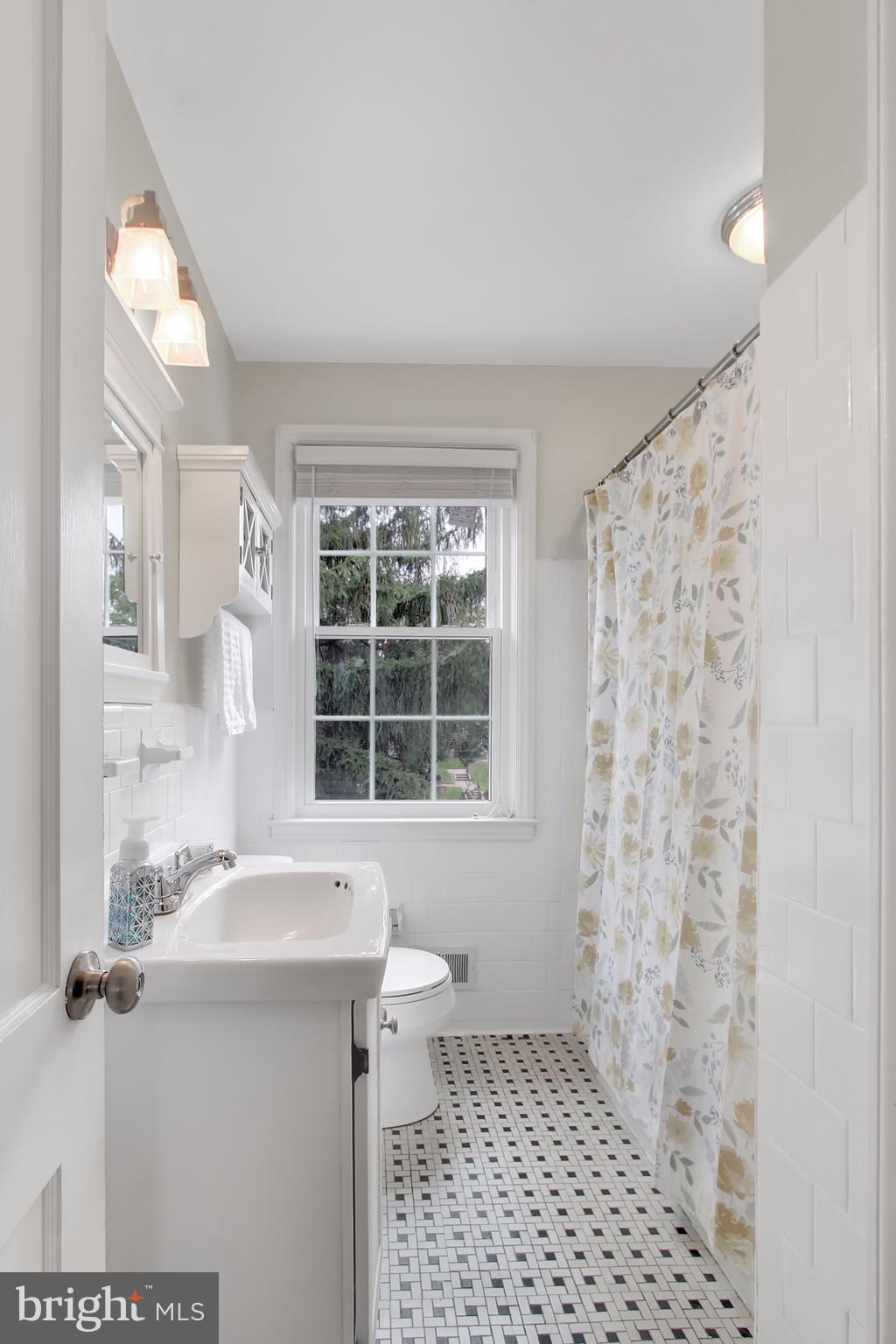 150 Dumbarton Road Baltimore, MD 21212 - Photo 13 of 30 a bathroom with a sink a toilet and a shower