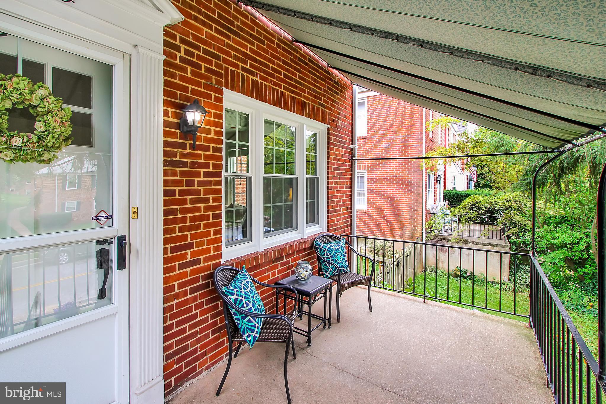 150 Dumbarton Road Baltimore, MD 21212 - Photo 26 of 30 a porch area with table and chairs