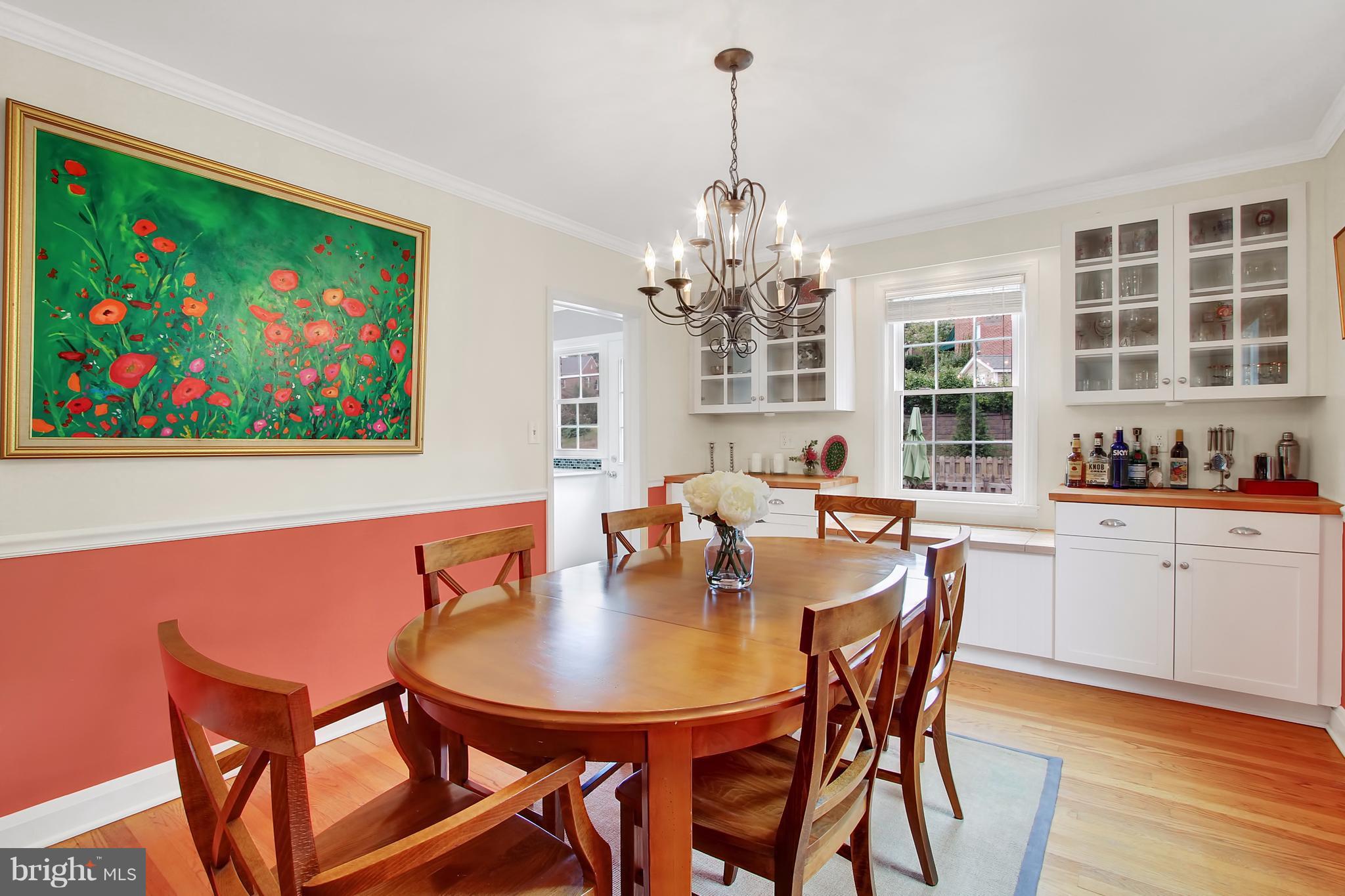 150 Dumbarton Road Baltimore, MD 21212 - Photo 5 of 30 a view of a dining room with furniture a chandelier and wooden floor