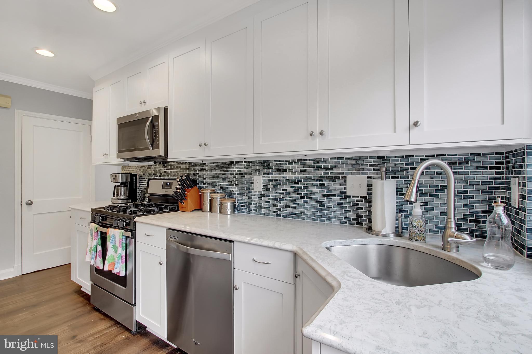 150 Dumbarton Road Baltimore, MD 21212 - Photo 7 of 30 a kitchen with stainless steel appliances granite countertop a sink stove and refrigerator