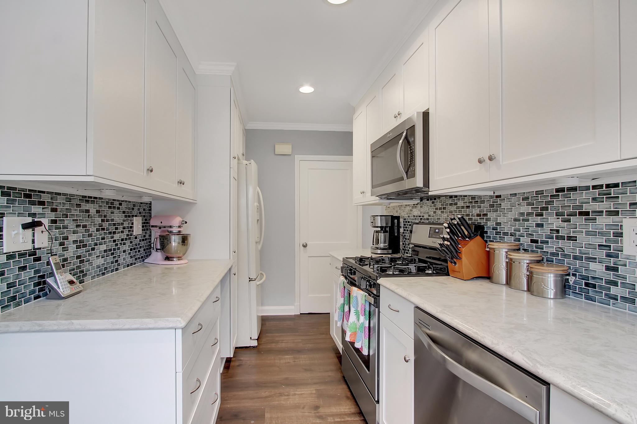 150 Dumbarton Road Baltimore, MD 21212 - Photo 9 of 30 a kitchen with a sink a stove and refrigerator