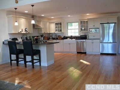 35 Bird Lane Copake, NY 12516 - Photo 4 of 9 a kitchen with stainless steel appliances kitchen island granite countertop wooden floors and cabinets