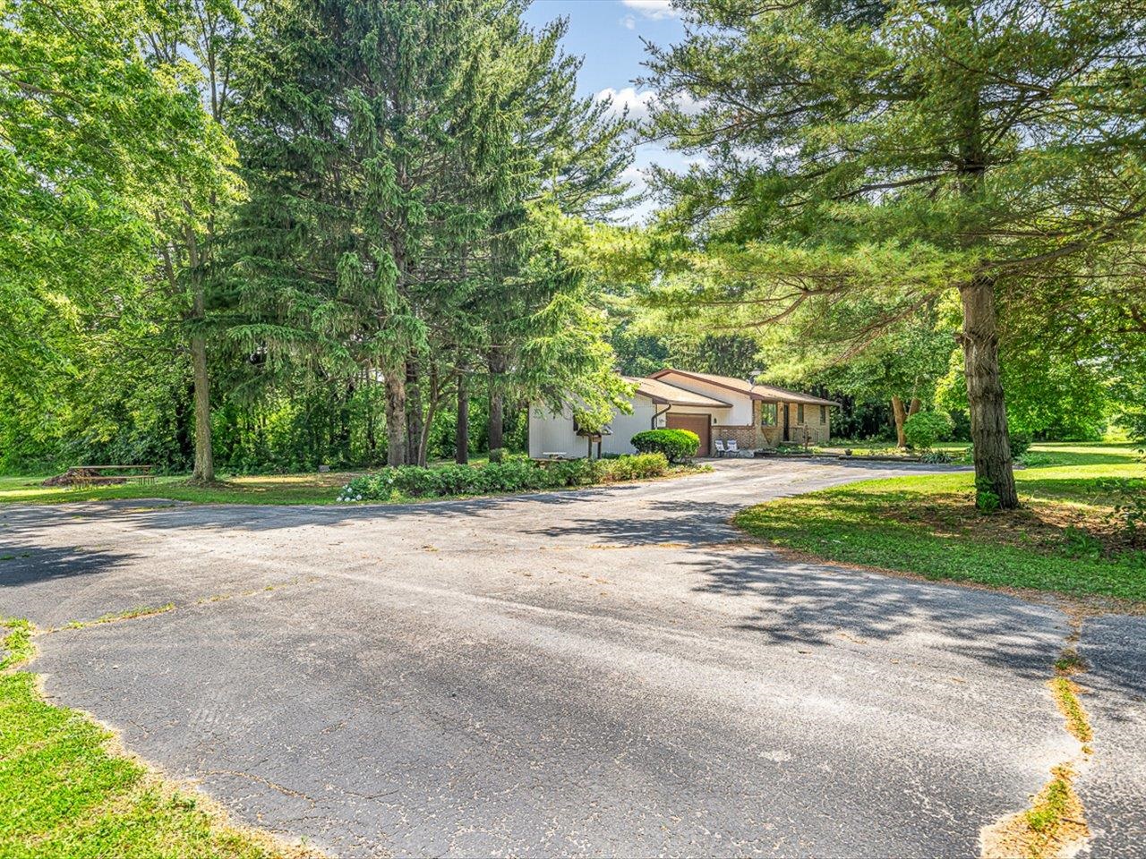 3621 Baxter Road Rockford, IL 61109 - Photo 54 of 56 a view of a house with a big yard and large trees